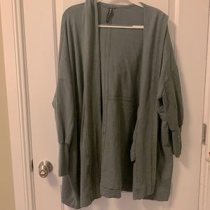 Baggy oversized cardigan, tight through forearms, thumb holes in sleeves